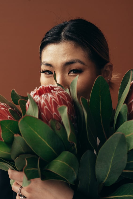 Asian woman with protea flowers