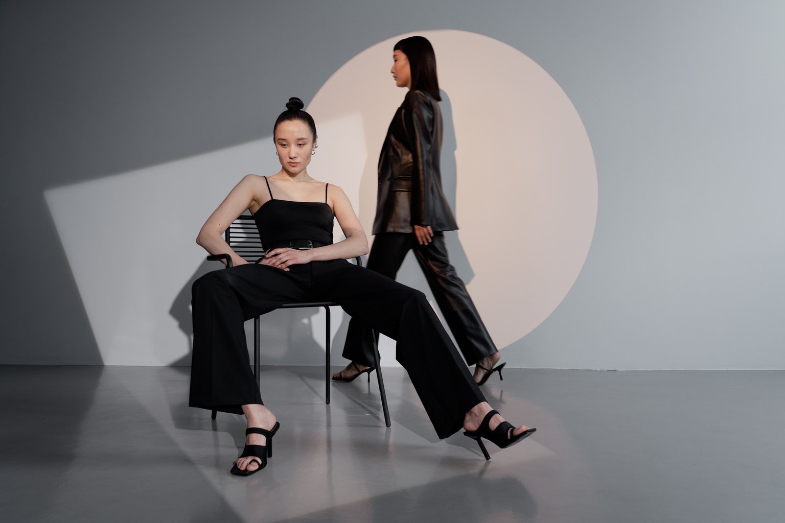 Two Female Models in Black Outfits Posing 